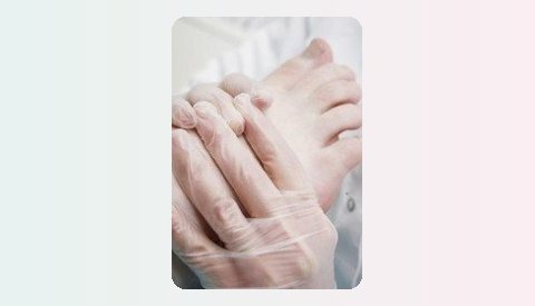Gloved and bare hands held together in a caring gesture